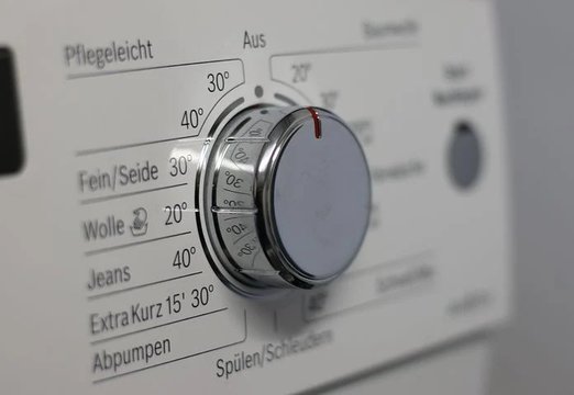 Close up shot of a laundry machine knob